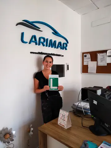 Alumno o alumna de Autoescuela Larimar con su placa L recién aprobada en la oficina (foto 2)
