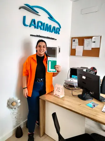Alumno o alumna de Autoescuela Larimar con su placa L recién aprobada en la oficina (foto 6)